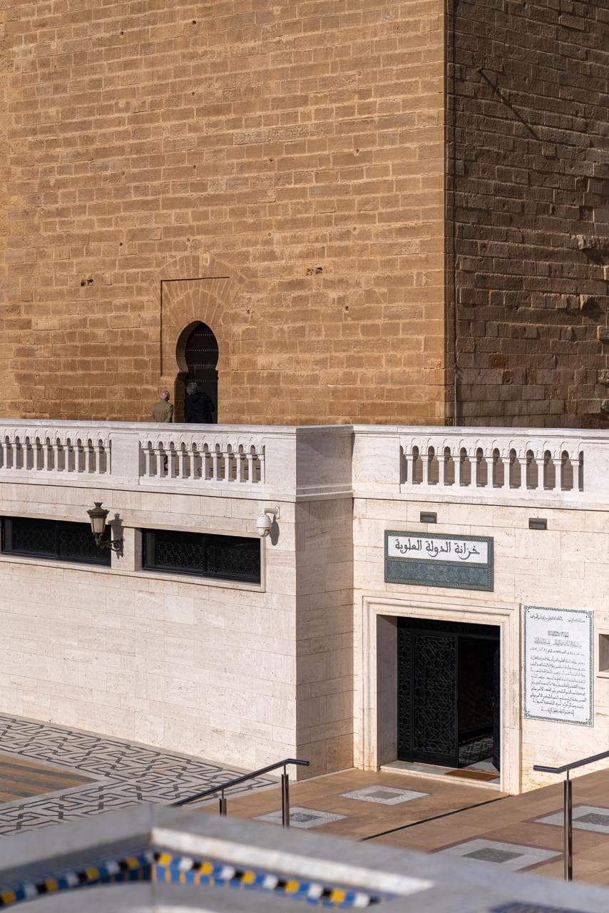 The doorway of the Alaouite state treasury below the ochre wall of the unfinished Hassan mosque, Rabat Morocco
