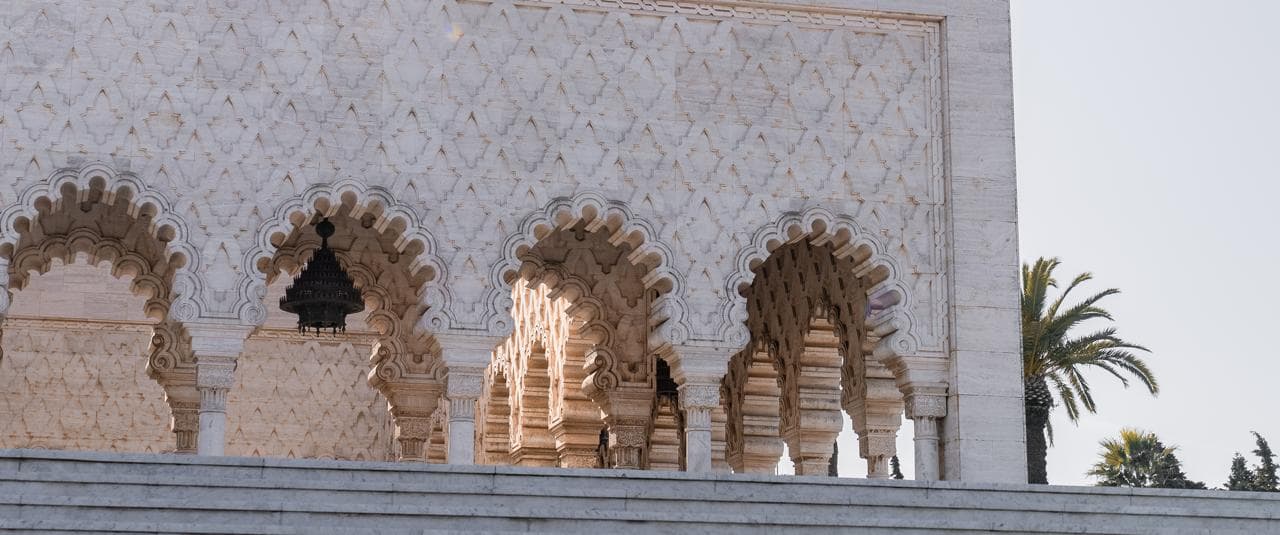 Interlaced marble arches and a hanging bronze lantern along the upper arcade of the Mausoleum of Mohammed V, Rabat Morocco