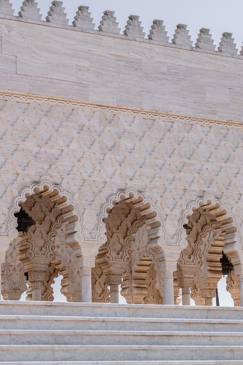 Detail of the carved white marble arcade and interlaced arches at the Mausoleum of Mohammed V, Rabat Morocco