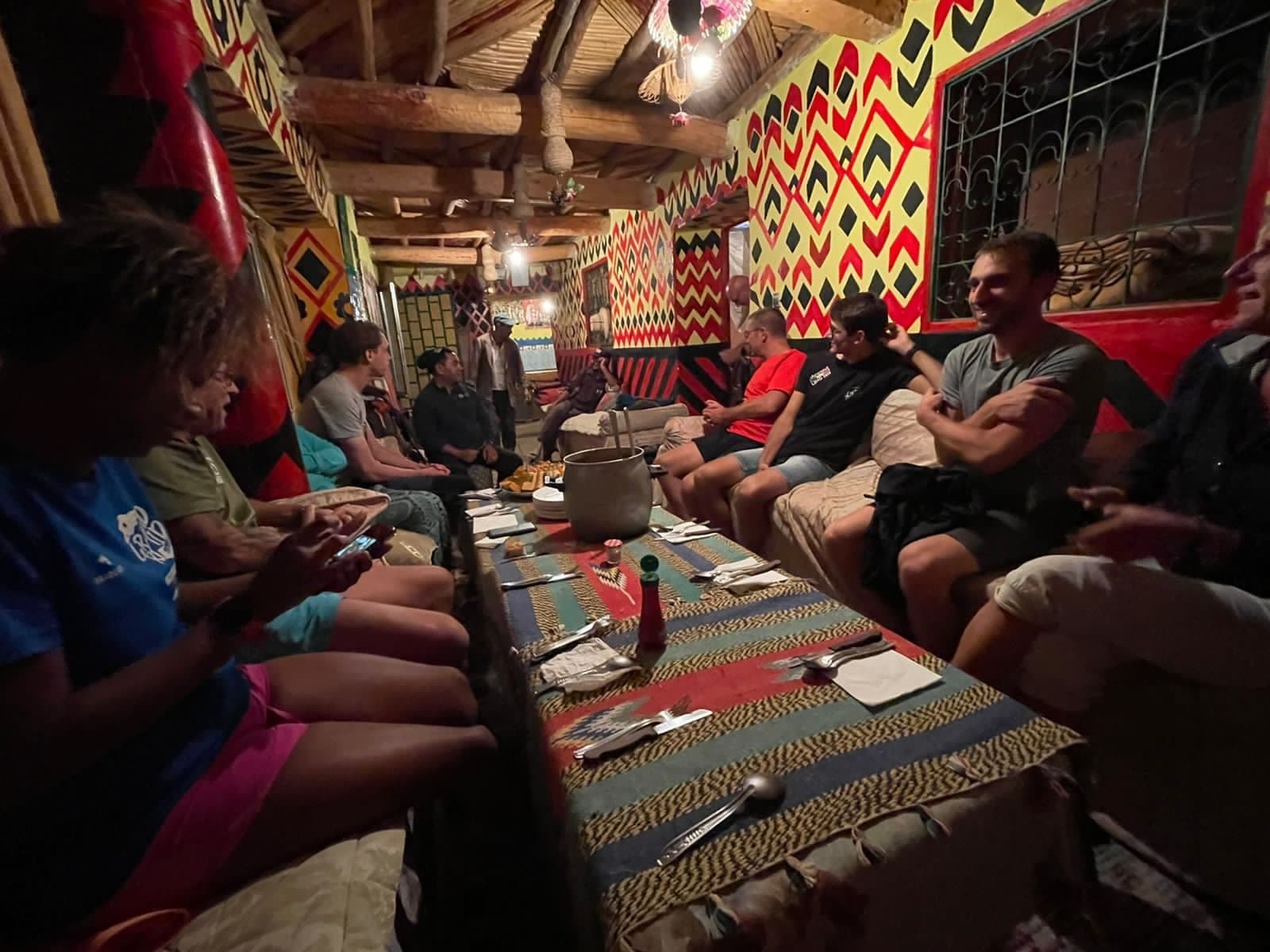 Our trekkers eating together at the long table of a mountain refuge, High Atlas Morocco